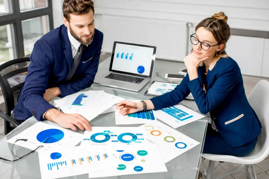 Business consultants reviewing performance data and workforce strategy, representing agile staff augmentation and remote staffing solutions.