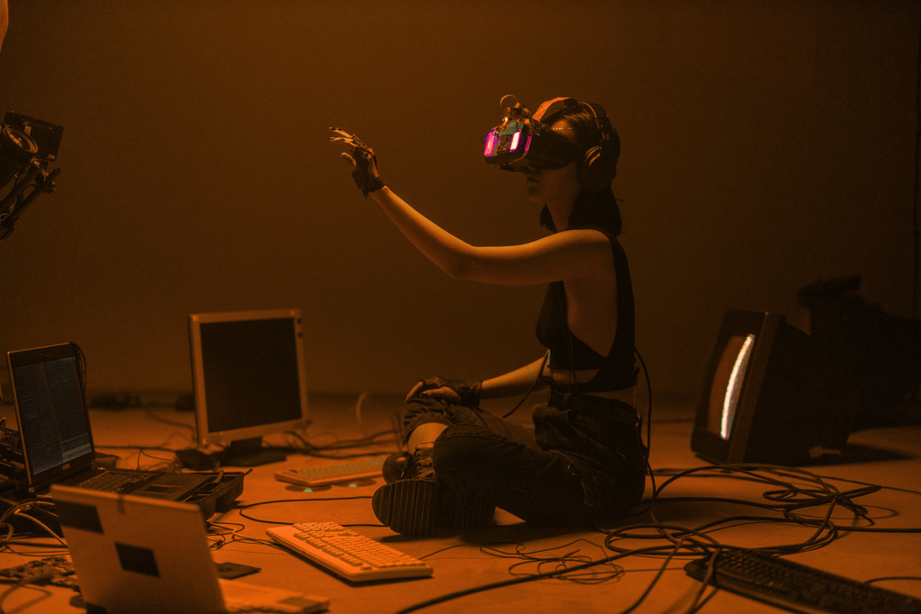 A person working at a computer under warm lighting, symbolizing the balance between AI tools and human judgment